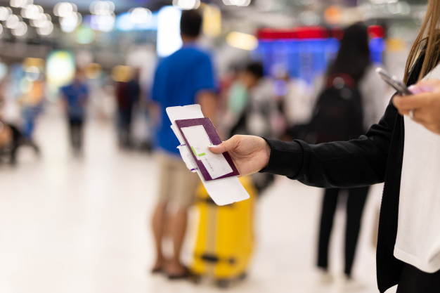 woman hand holding passport boarding pass airport blur background 42667 399